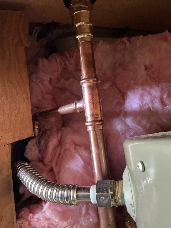 Replaced a 120-volt, 2000-watt heating element on a Rheem low boy water heater. Rebuilt the cold water supply line to install a vacuum breaker, which was previously absent and causing the tank to siphon when water service was shut off. All necessary parts were procured and the installation was completed with proper copper piping, brass fittings, and flexible connectors to ensure code-compliant operation and prevent backflow issues.