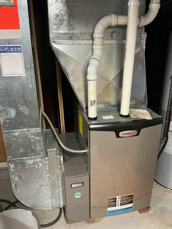 Completed comprehensive tune-up on 10-year-old Lennox air conditioning system, including outdoor condenser unit and indoor furnace. Performed standard maintenance procedures: inspected electrical connections and disconnect box, cleaned condenser coils, checked refrigerant levels, tested capacitor and contactor operation, verified proper airflow through ventilation fins, examined condensate drain lines and PVC venting system, inspected ductwork connections, and confirmed all safety controls were functioning correctly. System operating within manufacturer specifications with no deficiencies noted at time of service.
