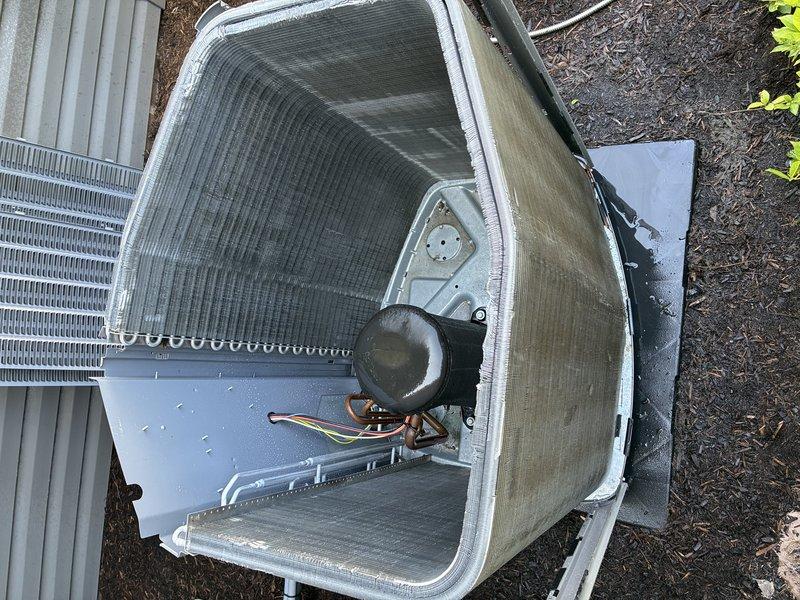 Completed comprehensive tune-up service on 11-year-old air conditioning system, including inspection of control board components, electrical connections, and outdoor condenser unit. Accessed and photographed interior control board showing all wiring harnesses, connectors, and circuit components in proper working condition. Removed outdoor unit access panel to inspect compressor motor, fan assembly, condenser coils, and verified all internal components operational with no visible damage or deterioration noted.
