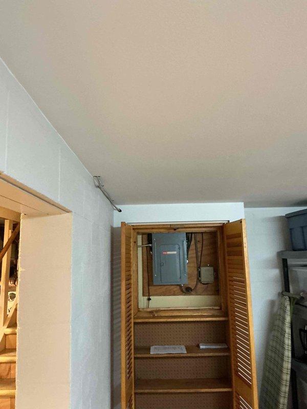 Conducted comprehensive site assessment for whole home generator installation. Evaluated electrical service panel location in basement stairwell area and assessed available clearances for equipment placement. Documented existing electrical infrastructure, including main service panel positioning and available routing paths for generator feed circuits. Surveyed basement utility space to determine optimal generator transfer switch location and conduit run requirements. Photographed current electrical configuration, ductwork placement, and structural elements to develop accurate material list and labor estimate for automatic standby generator system installation.
