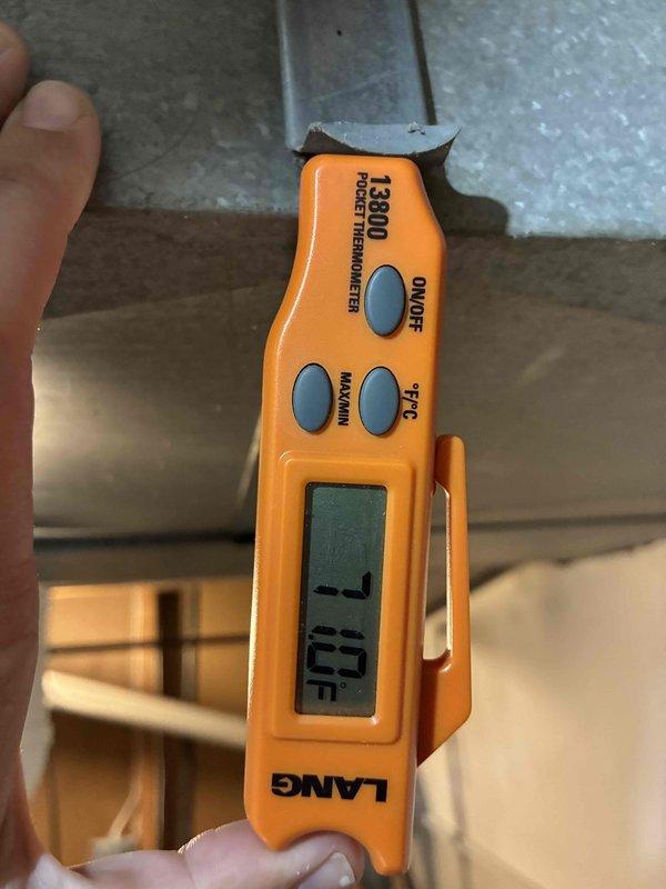 Completed routine HVAC maintenance visit on a 10-year-old air conditioning system. Performed temperature diagnostics using calibrated digital thermometer, recording supply air temperature of -7°F. Inspected evaporator coil, noting moderate accumulation of dust and oxidation on fins throughout the heat exchanger, with visible discoloration indicating normal wear for system age. Refrigerant lines and coil assembly found intact with no visible damage to housing or mounting components.