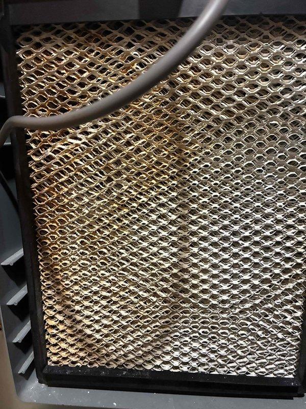 Completed routine HVAC maintenance visit on a 10-year-old air conditioning system. Performed temperature diagnostics using calibrated digital thermometer, recording supply air temperature of -7°F. Inspected evaporator coil, noting moderate accumulation of dust and oxidation on fins throughout the heat exchanger, with visible discoloration indicating normal wear for system age. Refrigerant lines and coil assembly found intact with no visible damage to housing or mounting components.