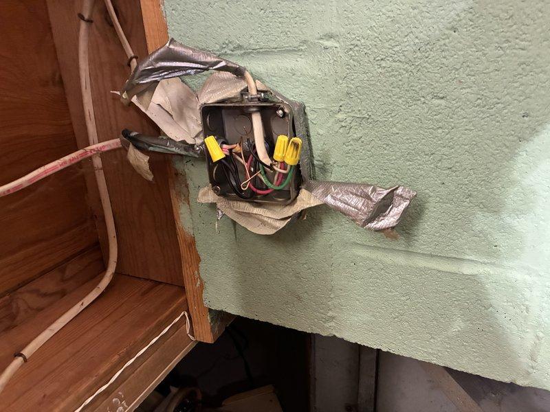 Responded to no cooling complaint on 7-year-old system. Inspected condensate drain pump assembly mounted in basement mechanical space and found unit not operating properly, preventing normal system operation. Tested electrical connections, verified proper wiring configuration with wire nuts securing line voltage connections, and confirmed pump motor functionality. System restored to normal cooling operation with condensate removal working as designed.