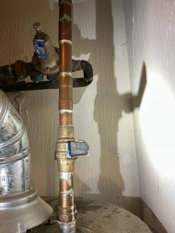 Conducted on-site assessment for water heater replacement and provided complimentary estimate for 40-gallon Rheem tanked water heater installation. Evaluated existing copper plumbing infrastructure, including vertical supply lines with soldered joints and brass shutoff valve, to determine compatibility and necessary modifications for new unit installation. Documented current utility room configuration and plumbing connections with photographic evidence for accurate proposal preparation.