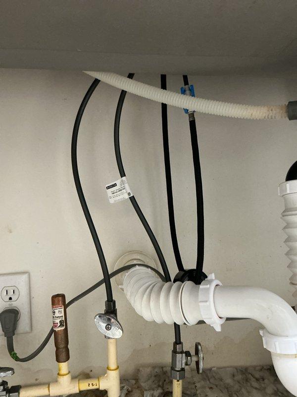 Replaced kitchen faucet with customer-supplied Delta model due to leak at sprayer hose connection under sink. Removed existing faucet assembly, installed new Delta faucet unit following manufacturer specifications, and verified all connections for proper operation with no leaks.