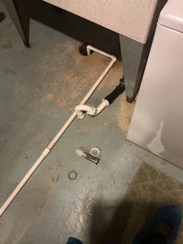 Responded to a water leak issue at the washing machine drain connection in the basement. Upon inspection, found that the washtub drain was not properly sealed where the washer discharge line connects, causing water to leak during the drain cycle. The leak was traced to previous plumbing work performed on the basement pipes in June. Removed and replaced deteriorated drain fittings and installed new rubber washers and chrome connectors to ensure a proper watertight seal. Addressed corroded copper piping in the drainage system that showed significant oxidation. Secured all pipe connections with appropriate hangers and tested the system by running a complete washer cycle to verify the leak was eliminated and drainage was functioning correctly.
