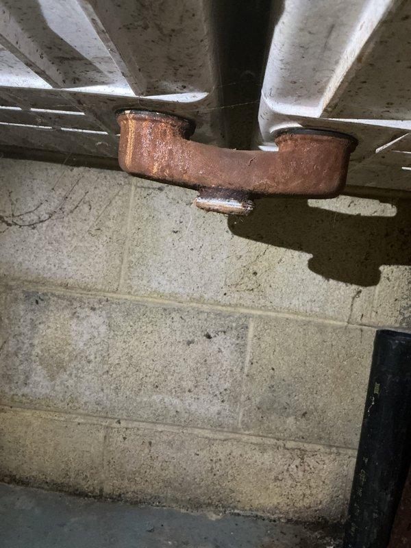 Responded to a water leak issue at the washing machine drain connection in the basement. Upon inspection, found that the washtub drain was not properly sealed where the washer discharge line connects, causing water to leak during the drain cycle. The leak was traced to previous plumbing work performed on the basement pipes in June. Removed and replaced deteriorated drain fittings and installed new rubber washers and chrome connectors to ensure a proper watertight seal. Addressed corroded copper piping in the drainage system that showed significant oxidation. Secured all pipe connections with appropriate hangers and tested the system by running a complete washer cycle to verify the leak was eliminated and drainage was functioning correctly.