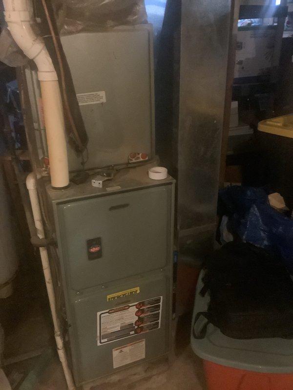 Conducted comprehensive estimate for complete HVAC system replacement including existing furnace, air conditioning unit, and water heater in residential basement mechanical room. Evaluated current equipment condition, assessed installation space constraints, documented existing ductwork and venting configuration with white PVC piping, and photographed copper refrigerant line routing along ceiling joists. Provided recommendations for new high-efficiency equipment specifications suitable for the existing infrastructure and prepared detailed replacement proposal.