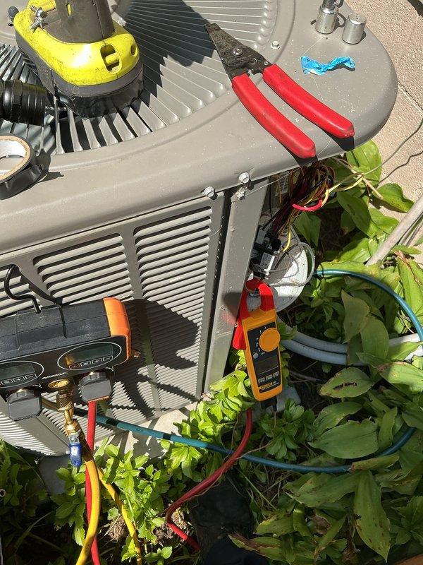 Responded to no-cooling call for property unoccupied for two years. Performed diagnostic testing on two outdoor condensing units. Removed top panels and inspected internal components including compressor, fan motors, and electrical systems. Used multimeter to test voltage and amperage at contactors, capacitors, and compressor terminals. Checked refrigerant pressures with manifold gauges. Inspected wiring connections, relays, and control boards for signs of corrosion or damage from extended non-use. Verified fan motor operation and capacitor values on both units.