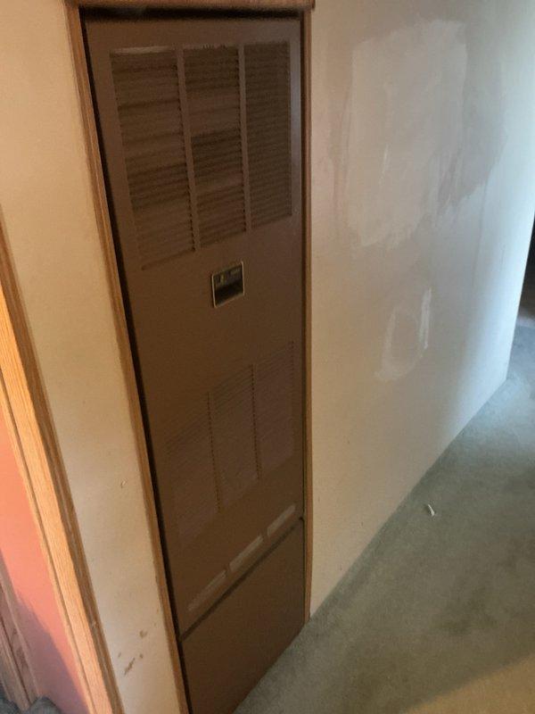 Completed full HVAC system installation for mobile home, including new furnace and air conditioning condenser unit. Installed outdoor condenser unit on concrete pad with proper electrical disconnect box and mounted interior furnace cabinet with ventilation louvers in wall recess, ensuring proper airflow and accessibility for future maintenance.