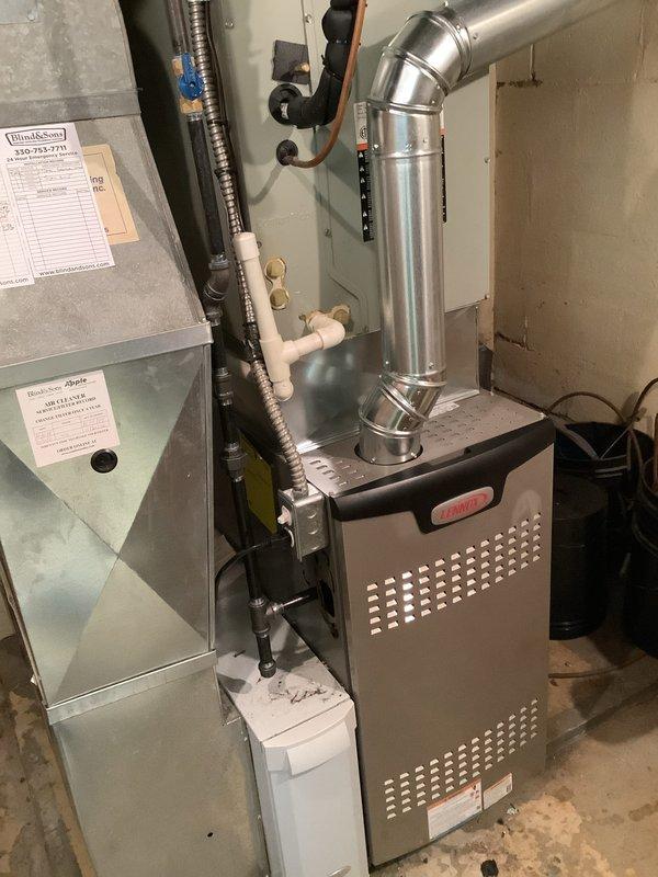 Completed installation of 80% efficiency gas furnace as part of secondary HVAC system upgrade. Installed new furnace unit in basement utility area with proper clearances and secure mounting on concrete floor. Routed and connected metal supply ductwork with 90-degree elbow transition to existing distribution system. Installed refrigerant lines, condensate drain piping using white PVC, and electrical conduit per manufacturer specifications and local code requirements. Verified all connections for proper fit and seal. Installed carbon monoxide alarm in accordance with safety requirements for fuel-burning appliances. Tested system operation to ensure proper ignition, airflow, and safety control functionality. All components operational and installation meets industry standards.