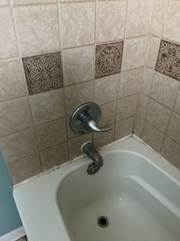 Replaced shower fixtures in bathroom with decorative tile surround. Customer provided new fixtures; verified cartridges were included with replacement components before proceeding with installation. Successfully removed existing chrome tub/shower faucet assembly and shower head, then installed new fixtures ensuring proper sealing and water flow functionality.