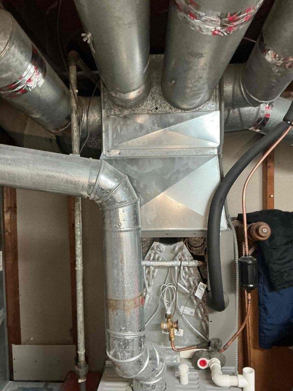 Completed cooling maintenance on Concord furnace system with integrated air handler. Performed comprehensive tune-up inspection of HVAC equipment, including examination of ductwork, refrigerant lines, condensate drainage system, and electrical connections. System confirmed operational with all components functioning properly at time of service.