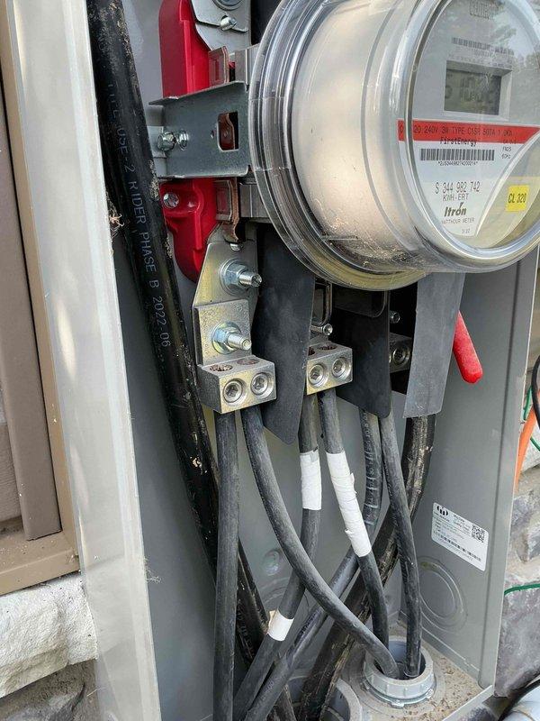 Conducted comprehensive site assessment for whole home generator installation. Documented existing electrical service entrance configuration, including current meter base assembly, service entrance conductors, and main panel connections. Photographed meter panel installation showing digital meter housing, terminal blocks, and 600V rated service cables with proper securing and connection points. Evaluated interior panel components including bus bars, terminal connections, and cable entry points to determine compatibility and capacity requirements for generator integration. Assessment included verification of service entrance conductor sizing, available connection points, and necessary modifications for automatic transfer switch installation.