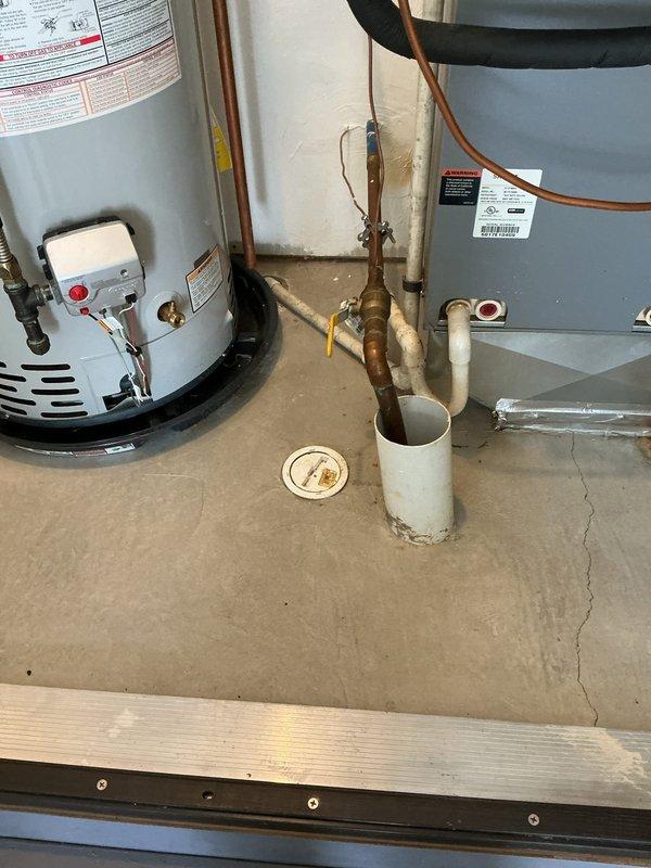 Responded to no hot water complaint at 8-year-old residence. Upon inspection, determined Bradford White tanked water heater pilot light would not remain lit, rendering unit inoperable. Evaluated existing water heater system including all plumbing connections, copper piping, brass fittings, and safety components. Documented current installation configuration showing Defender Safety System unit with associated gas line, water supply lines, pressure relief valve, and venting system. Provided free estimate for complete Bradford White tanked water heater replacement due to pilot light failure preventing hot water production throughout home.