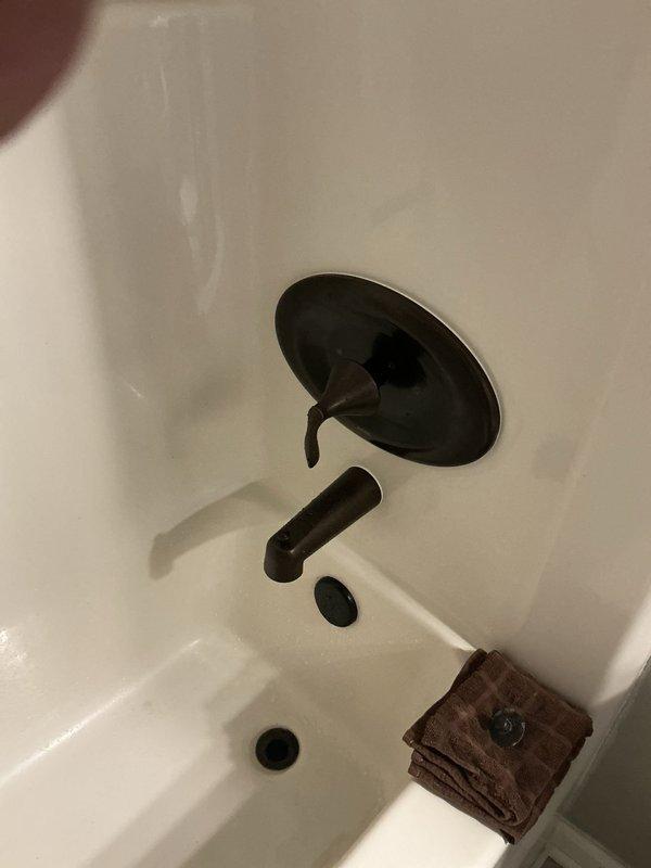 Replaced upstairs bathtub shower valve assembly including installation of new rough-in valve with integral stops and repair plate. Installed oil-rubbed bronze Moen Eva trim package to match existing bathroom fixtures. All components ordered with appropriate lead time and installation completed upon parts arrival, resulting in fully functional tub-shower control system with updated aesthetic finish.