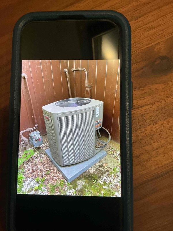 Completed routine maintenance visit on 3-year-old air conditioning system for MVP customer. Performed standard inspection of indoor air handler unit and outdoor condensing unit, verified system operation, and documented equipment condition with photos showing thermostat controls and exterior condenser placement on concrete pad.