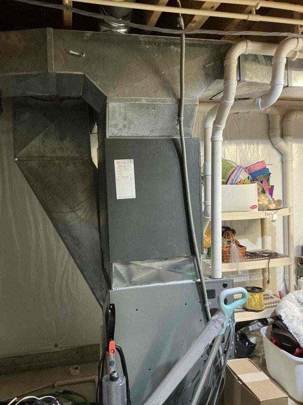 Conducted on-site evaluation for complete HVAC system replacement at residential property. Assessed existing outdoor condensing unit with horizontal fin grille pattern and indoor air handler/furnace system located in basement utility area. Documented current equipment configuration, including ductwork connections and system placement relative to existing plumbing infrastructure and storage areas. Provided comprehensive replacement estimate for new HVAC system installation.