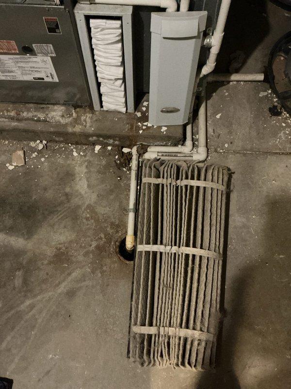 # HVAC Service Completed

Responded to no cooling call on residential air conditioning system over 10 years old. Unit was completely non-operational upon arrival. Inspection revealed severely restricted airflow due to heavily soiled evaporator coil and completely clogged air filter. The evaporator coil exhibited extensive dust and debris accumulation coating the vertical fins, resulting in significant reduction of heat transfer capacity and airflow restriction. Air filter was found to be excessively loaded with gray dust and debris throughout the pleated media, indicating extended period without maintenance.

Removed and replaced disposable air filter with new filter appropriate for system specifications. Cleaned evaporator coil to restore proper airflow and heat transfer efficiency. Verified system operation and confirmed adequate airflow through supply registers. Advised homeowner on importance of regular filter replacement every 1-3 months to prevent future system failures and maint