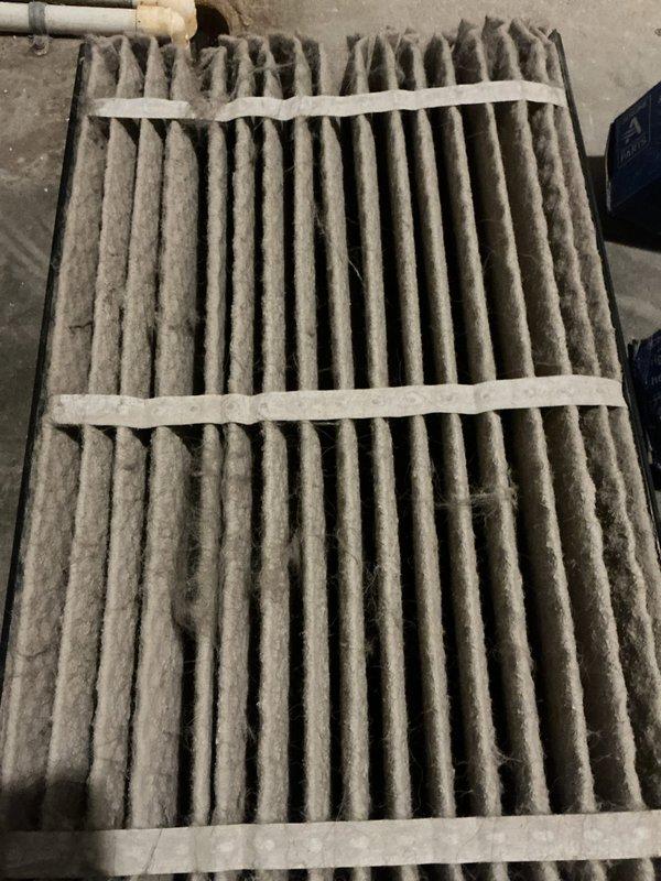 # HVAC Service Completed

Responded to no cooling call on residential air conditioning system over 10 years old. Unit was completely non-operational upon arrival. Inspection revealed severely restricted airflow due to heavily soiled evaporator coil and completely clogged air filter. The evaporator coil exhibited extensive dust and debris accumulation coating the vertical fins, resulting in significant reduction of heat transfer capacity and airflow restriction. Air filter was found to be excessively loaded with gray dust and debris throughout the pleated media, indicating extended period without maintenance.

Removed and replaced disposable air filter with new filter appropriate for system specifications. Cleaned evaporator coil to restore proper airflow and heat transfer efficiency. Verified system operation and confirmed adequate airflow through supply registers. Advised homeowner on importance of regular filter replacement every 1-3 months to prevent future system failures and maint