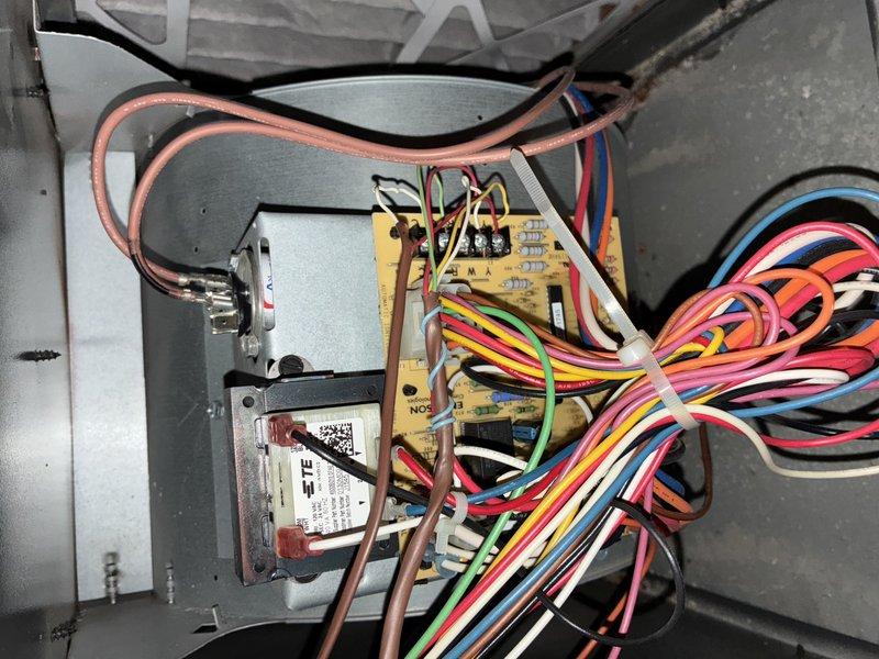 Completed MVP recurring cooling maintenance visit on HVAC system. Performed comprehensive inspection of evaporator coil assembly, noting dust accumulation on aluminum fins and normal condensation present at panel junctions. Documented control board wiring configuration and electrical connections, verifying all wire harness connections to yellow circuit board were secure. All system components found operational with typical wear patterns consistent with regular use.