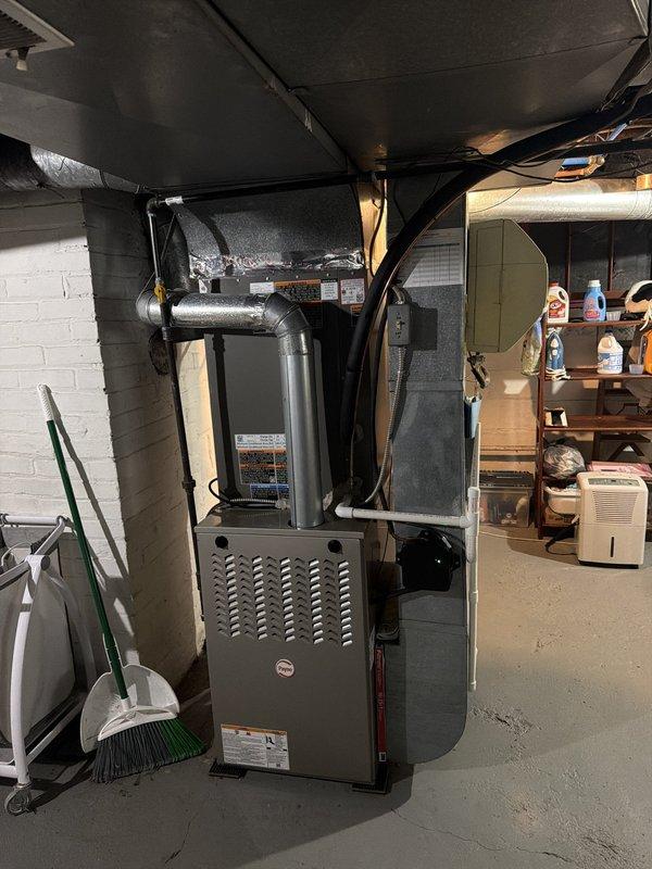 Completed installation of new air conditioning system with matching evaporator coil. Installed outdoor condensing unit with proper refrigerant line connections, brass service valves, and insulated suction line. Indoor air handler integrated with existing ductwork system, including reflective insulation on supply plenums and proper drainage connections established at outdoor unit location.