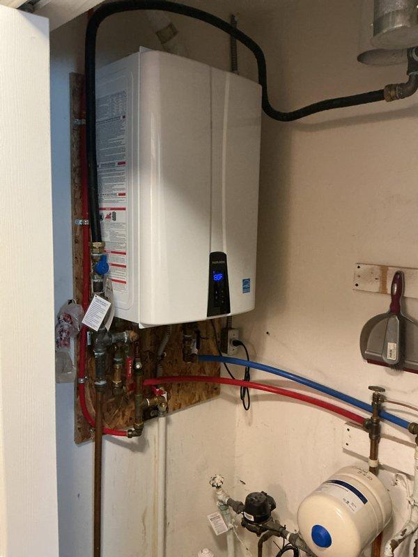 Replaced recirculation pump and flow sensor on Navien tankless water heater per manufacturer specifications. Verified proper operation of digital control panel displaying 130°F, tested all plumbing connections including PEX and copper supply lines, and confirmed system functionality with no leaks detected.