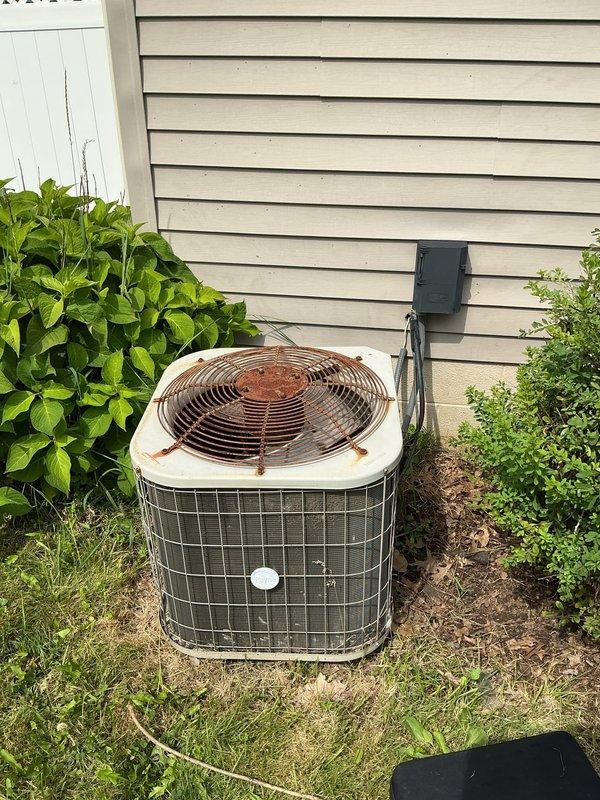 Responded to no cooling complaint on 7-year-old Payne PA13NA024-B air conditioning system. Found outdoor unit running with condenser fan operational but system not producing cold air throughout residence. Performed diagnostic evaluation of electrical components including contactor and dual capacitor. Inspected refrigerant circuit and determined system had lost refrigerant charge. Identified leak, performed repairs, evacuated system, and recharged with proper amount of R-410A refrigerant to manufacturer specifications. Verified proper amperage draw, temperature split, and system operation upon completion with unit cooling effectively.