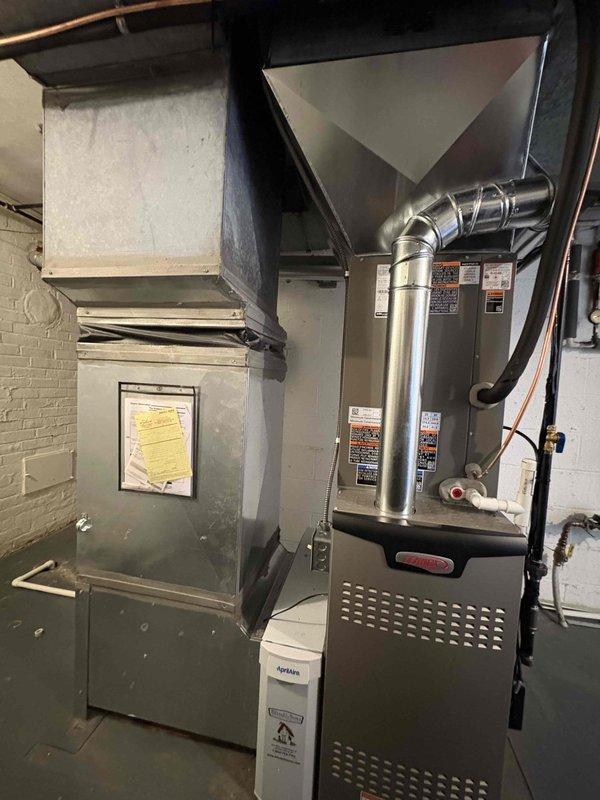 Completed full HVAC system installation including an 80% efficiency Amana furnace and matching air conditioning unit. The furnace was installed in the basement mechanical room with proper ductwork connections, plenum assembly, and filtration system. All warning labels and specification plates were properly affixed to equipment surfaces per manufacturer requirements. The outdoor condensing unit was positioned on a vibration-dampening rubber pad against the exterior wall with appropriate clearances. Electrical conduit and disconnects were installed to code, with weatherproof junction boxes mounted for exterior connections. Copper refrigerant lines were run between the indoor and outdoor units. System was tested, charged to specifications, and verified operational.