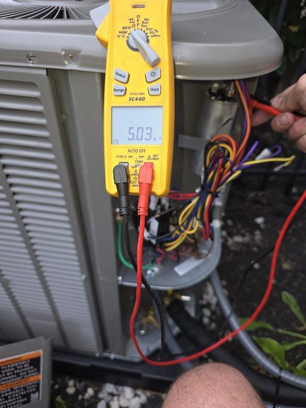 Responded to service call for recently installed unit experiencing loud banging noise. Performed diagnostic testing of electrical components using digital multimeter, measuring voltage at 5.03V. Inspected fuses, wiring connections, and internal components to identify source of operational issue. Documented equipment condition with photos showing electrical testing procedures and internal component assessment.