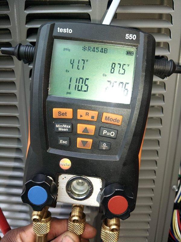 Completed second air conditioning installation with evaporator coil replacement in residential basement location. System was charged with R454B refrigerant to manufacturer specifications, with final operating pressures reading 110.5 psi and temperatures stabilized at 41.7°F suction and 87.5°F liquid line. Used Testo 550 digital manifold gauge set to verify proper refrigerant charge and system performance. All ductwork connections were secured to the furnace cabinet, and the complete HVAC system was tested for proper operation and airflow distribution.
