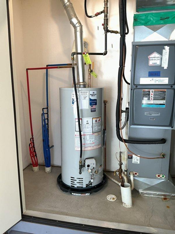 Replaced an 8-year-old Bradford White water heater that was no longer staying lit with a new Bradford White 40-gallon short water heater featuring an 8-year manufacturer warranty. Installed a thermal expansion tank on the horizontal copper water line to protect the system from excessive pressure buildup. All connections were secured, system was tested for proper operation, and the installation was completed in the utility closet alongside existing HVAC equipment.