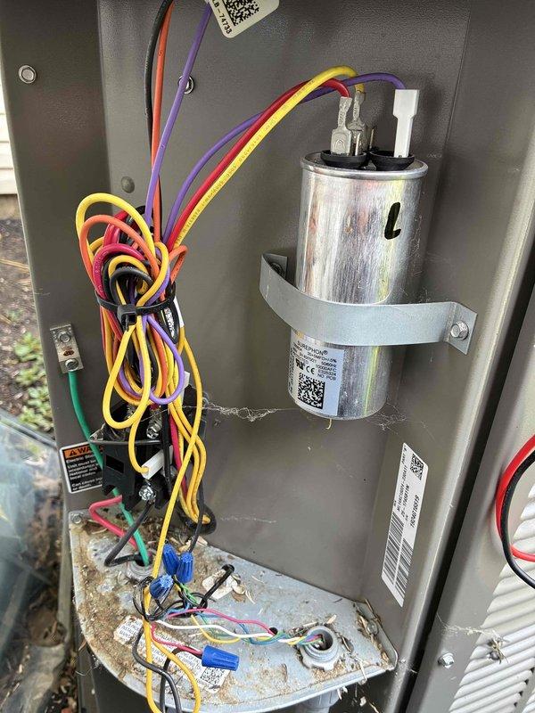 Completed MVP Cooling Visit maintenance on residential Lennox HVAC system. Inspected electrical control panel components including capacitor, wiring connections, and terminal blocks; all found to be functioning within normal parameters despite visible wear and environmental exposure. Verified proper operation of cooling system and documented equipment condition with interior panel and installation area photography.