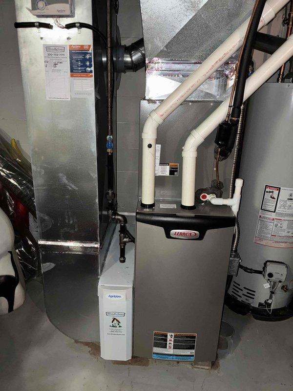 Completed MVP Cooling Visit maintenance on residential Lennox HVAC system. Inspected electrical control panel components including capacitor, wiring connections, and terminal blocks; all found to be functioning within normal parameters despite visible wear and environmental exposure. Verified proper operation of cooling system and documented equipment condition with interior panel and installation area photography.