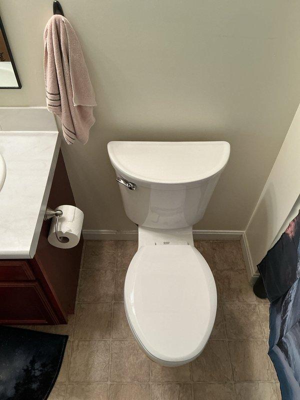 Replaced existing toilet in basement bathroom with new American Standard Champion chair height elongated model. Removed old fixture, installed new toilet with proper sealing and mounting, and connected water supply line using braided stainless steel flex line to existing angle stop valve. Verified proper operation, checked for leaks, and ensured secure installation on tile flooring.