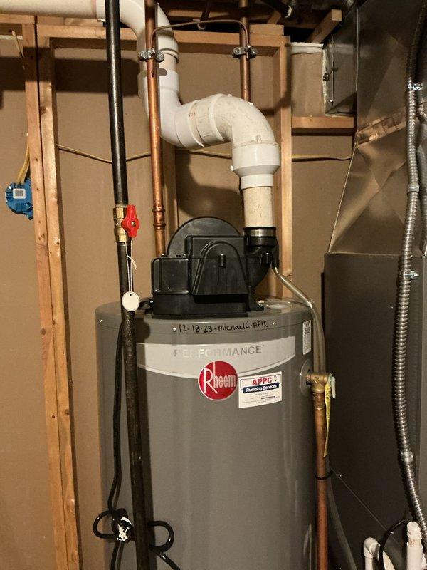 Responded to customer concerns regarding earthy odor from water following previous service visit. Performed inspection of Rheem Performance water heater installation and associated sump pump system with PVC discharge piping. Documented existing equipment configuration including pump mounted on water heater, copper supply lines with shut-off valves, and proper venting arrangements to verify installation meets code requirements and manufacturer specifications.