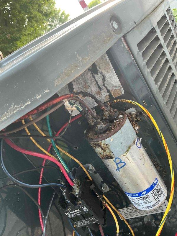 Completed MVP cooling maintenance visit on 13-year-old system. Upon inspection, found significant rust and corrosion on capacitor terminals and housing, along with debris accumulation in electrical compartment. Performed system diagnostics using test equipment to verify operational parameters. Cleaned internal components, removed debris and organic material from access panel area. Checked electrical connections, refrigerant lines, and contactor operation. System tested and confirmed operational despite age-related wear on components.