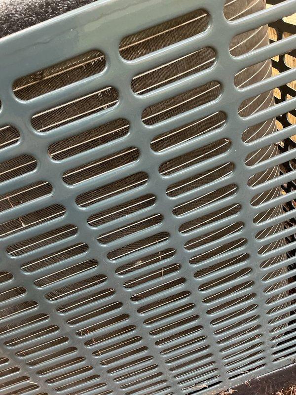 Performed preventative maintenance inspection on 4-year-old air conditioning system for MVP customer. Conducted thorough visual examination of outdoor condensing unit, confirming heat exchanger coils and protective grilles were clean and in proper working condition, with no debris obstruction or damage observed to finned components.