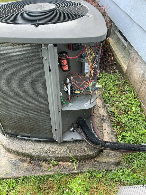 # HVAC Maintenance - Cooling

Performed comprehensive annual preventive maintenance on residential central air conditioning system approximately 3-4 years old. Conducted visual inspection of outdoor condensing unit, noting normal weathering and environmental exposure on cabinet and coil surfaces with accumulated dirt and grime on condenser fins. Removed access panel to inspect internal electrical components including capacitor, contactor assembly, and wiring connections. Verified all electrical connections were secure with no signs of overheating or deterioration. Checked capacitor condition and mounting. Inspected fan motor and compressor for proper operation. Noted drainage line routing and foundation clearance were appropriate.

Exterior condenser coil showed moderate dirt accumulation affecting heat transfer efficiency. Unit positioned on stable concrete pad with adequate clearance from structure. Electrical disconnect box and conduit connections verified secure. Foundation ventila
