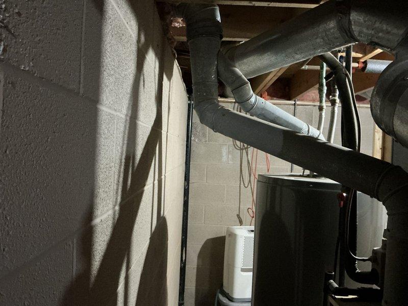 Conducted comprehensive HVAC system replacement estimate for a medium-sized residential property (1500-3000 sq.ft.) requiring both heating and cooling capabilities. Assessed existing basement installation with natural gas furnace and air conditioning system, evaluating current ductwork configuration, electrical service connections, and equipment placement in unfinished utility area. Recommended Lennox vertical upflow/downflow gas furnace and air conditioning system appropriate for the home's square footage and existing infrastructure, documented equipment specifications and installation requirements with photographic evidence of current mechanical systems and exterior electrical service panel.
