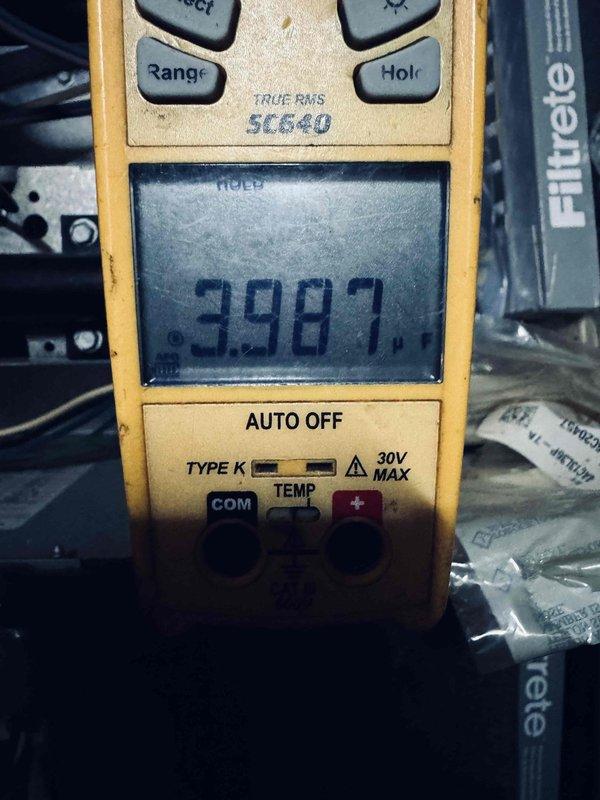 Responded to service call for 10-year-old air conditioning system not cooling correctly. Upon arrival, confirmed customer understanding of diagnostic service charge for non-operational equipment. Performed comprehensive system inspection and diagnostics using digital multimeter to test electrical components and control board functionality. Measured voltage readings at control panel, recording 398.7 volts during testing sequence. Inspected internal wiring connections, terminal blocks, and circuit board within the control enclosure. Evaluated all electrical connections including multiple wire runs and control circuits. Documented system conditions with photos of control panel interior and diagnostic meter readings for service records.