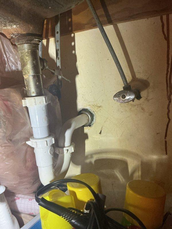 Responded to a bathtub drainage issue in a 70-year-old home with a Bath Fitter installation. Upon inspection, accessed the drain assembly from the basement level and identified a clog in the P-trap system. Utilized wet/dry vacuum equipment to clear the blockage and restore proper drainage function. Verified water flow and confirmed the bathtub was draining correctly upon completion.