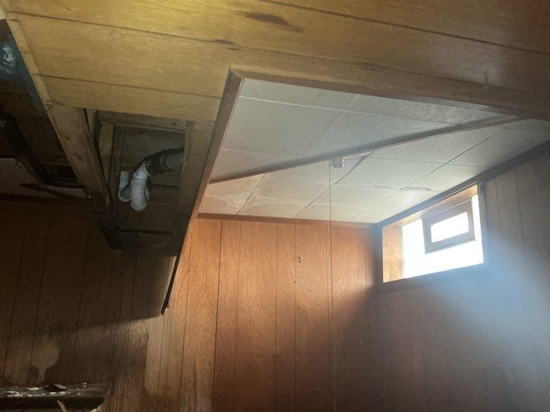 Responded to a bathtub drainage issue in a 70-year-old home with a Bath Fitter installation. Upon inspection, accessed the drain assembly from the basement level and identified a clog in the P-trap system. Utilized wet/dry vacuum equipment to clear the blockage and restore proper drainage function. Verified water flow and confirmed the bathtub was draining correctly upon completion.