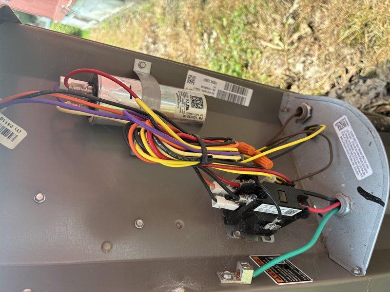 Performed standard preventive maintenance tune-up on residential air conditioning system. Inspected condenser unit components including fan motor assembly, blower blades, and electrical connections within control panel. Verified proper operation of capacitor, checked all wire terminations and connections for security, and documented equipment condition through photos. All components found to be in good working order with no deficiencies noted on this relatively new system.