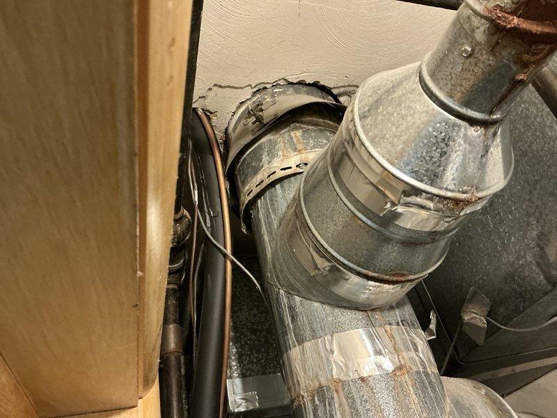 Conducted estimate for complete HVAC system replacement at residential property. Evaluated existing 17-year-old American Standard furnace located in basement and 24-year-old Goodman air conditioning unit positioned outside. Customer requested replacement due to equipment age rather than active system failures. Documented current equipment condition through photographs showing furnace installation on concrete block platform with metal ductwork, electrical conduits, and associated piping. Assessed existing ductwork routing through floor structure, noting galvanized steel construction with visible age-related wear and oxidation at connection points. Reviewed utility space configuration and equipment accessibility for future replacement work.