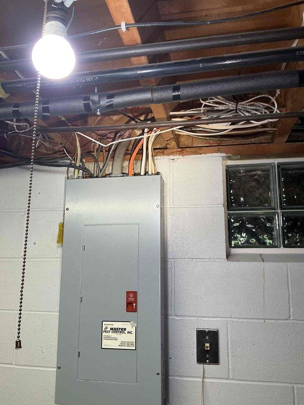 Conducted on-site electrical estimate for whole-house generator installation at residential property. Assessed existing electrical panel location in basement utility area and evaluated exterior mounting options near HVAC equipment on side of home. Documented current electrical infrastructure including main service panel, available space for transfer switch installation, and optimal generator placement considering clearance requirements from structure and landscaping.