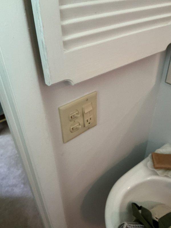 Completed comprehensive GFCI outlet upgrade and electrical safety improvements throughout the residence. Addressed multi-branch circuit wiring concern in electrical panel where one circuit was sharing a common neutral wire, requiring double pole breaker installation for proper safety shutdown capability. Replaced standard outlets with GFCI-protected devices in bathrooms (GFCI/switch combination units), kitchen counter area, and laundry area to meet current electrical code requirements. Modified washer outlet configuration by installing GFCI breaker at panel instead of receptacle-level protection to ensure accessibility for resets without requiring access behind appliance. Evaluated kitchen counter outlet placement in relation to existing tile backsplash and adjusted installation approach due to tight spacing constraints near decorative tile work. All GFCI devices installed in readily accessible locations per NEC requirements for ease of testing and resetting.