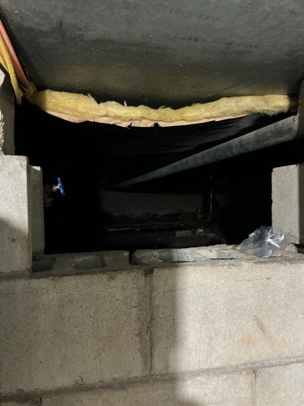 Responded to water leak under kitchen sink. Upon arrival, found dime-sized hole in the gooseneck (drain tailpiece) causing active leak into cabinet. Assessed damage to cabinet interior and placed bucket to contain water. Recommended replacement of corroded drain assembly to prevent further water damage.