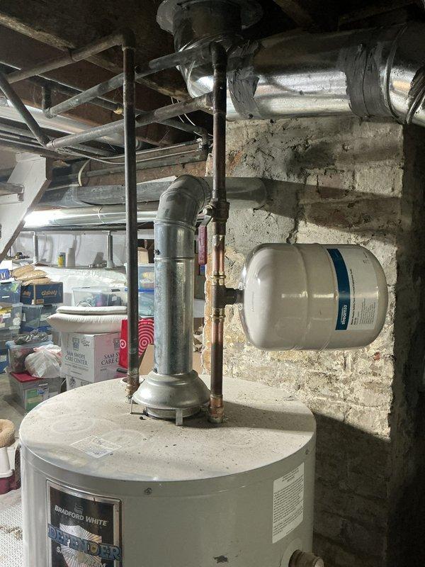 Replaced failed pressure reducing valve in basement that was actively leaking. Installed new Webstone ball valve to replace malfunctioning main water shut-off valve that was not fully closing. Added thermal expansion tank at water heater location, which was previously absent from the system—a critical safety component required since the PRV functions as a check valve and prevents thermal expansion from dissipating back through the water main. All copper piping connections were properly soldered, and the new brass ball valve provides reliable full-port shut-off capability. System was tested for proper operation and verified no leaks at any connection points.