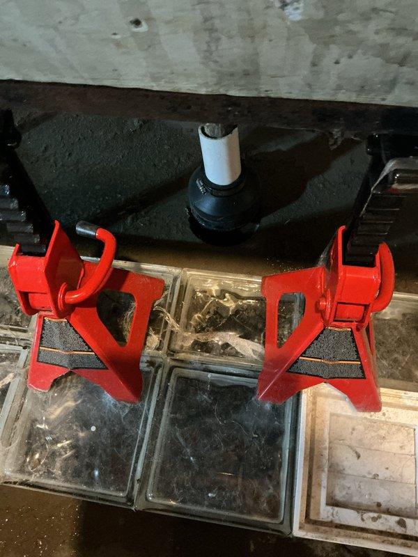 Responded to utility tub drain backup caused by washing machine discharge. Accessed drain line in basement workspace, elevated equipment using jack stands for proper clearance, and cleared obstruction from drain system. Restored proper drainage flow to utility tub, tested system operation with multiple discharge cycles to verify complete resolution.